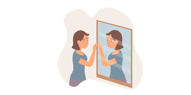 Alt: Hình ảnh một người đang suy tư và ôm đầu, thể hiện sự lo lắng và tự ti